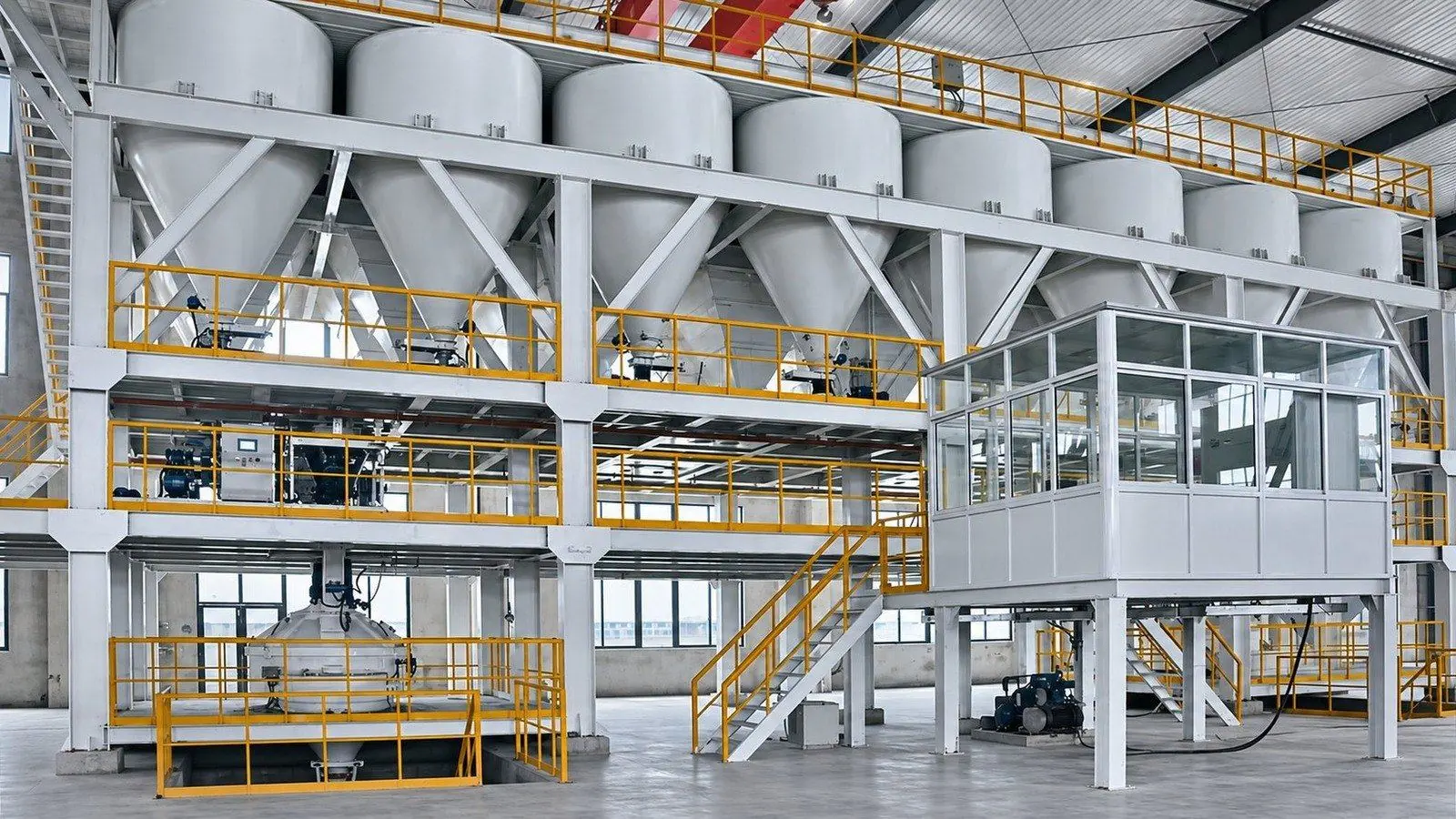 Automated batching line with a row of silos, weighing floors and a control room