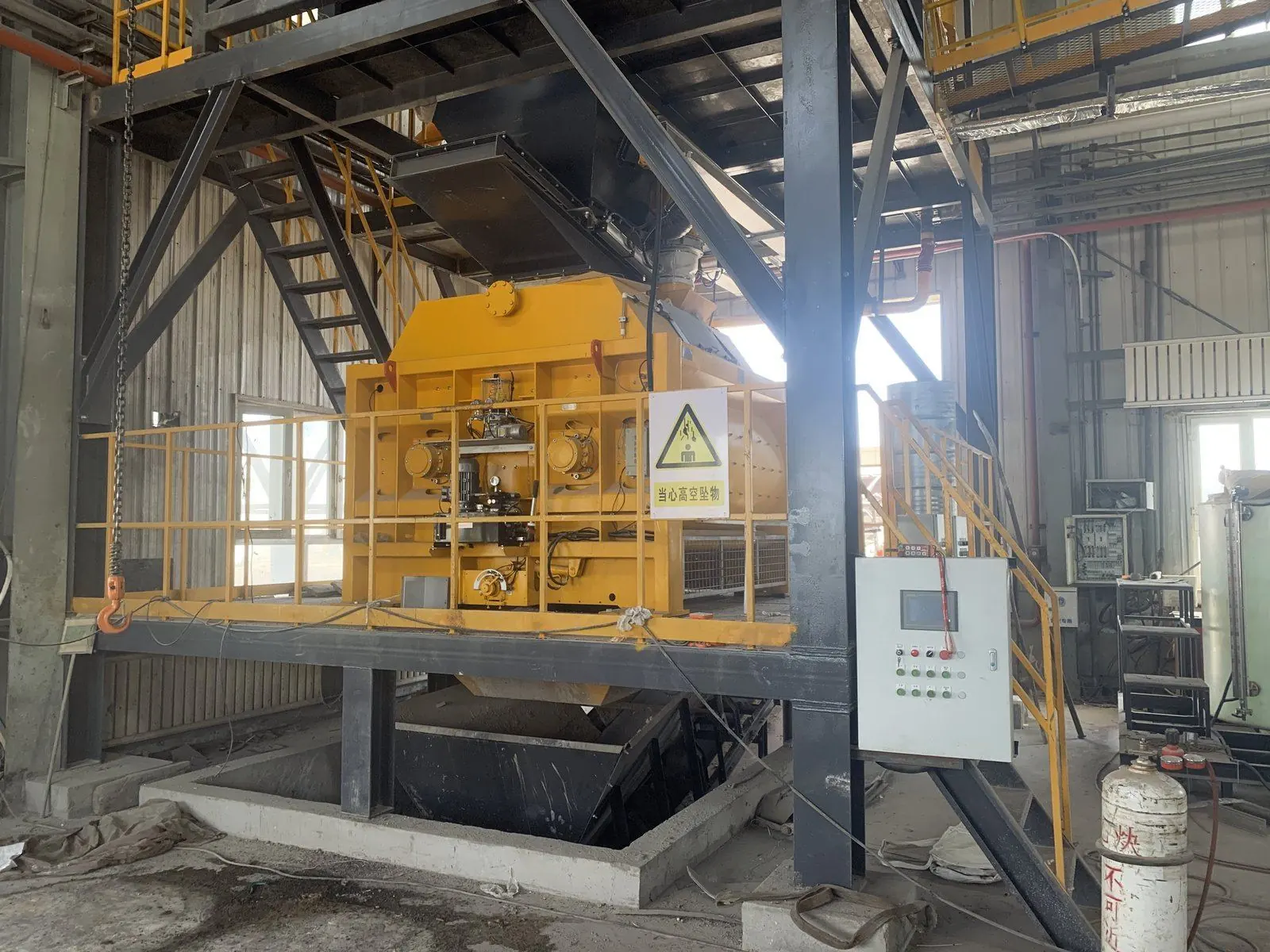 3000 L twin-shaft mixer above its discharge pit on a hazardous-waste solidification line