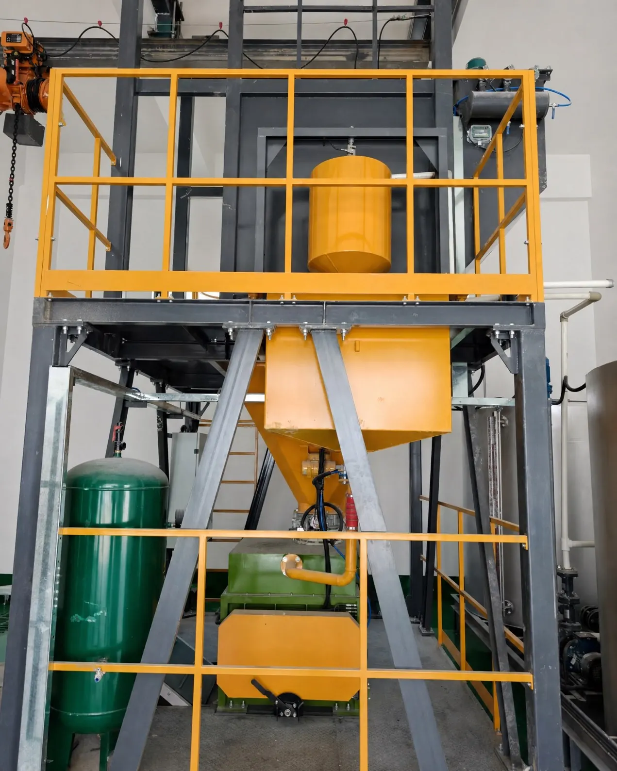 Bag hoist and weigh hopper above a twin-shaft mixer in a compact frame